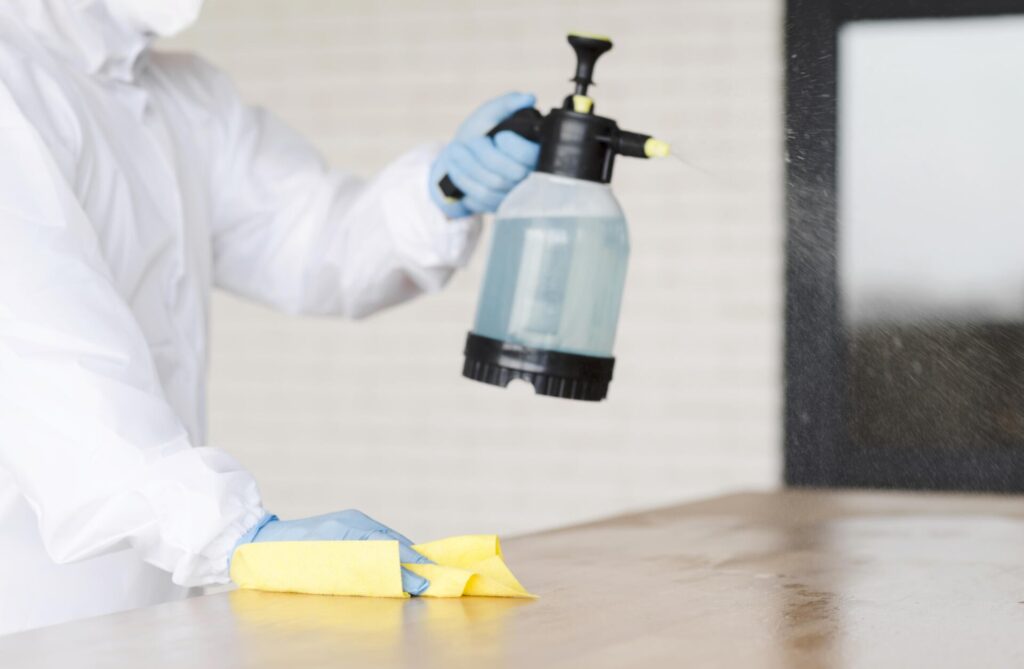 close up man holding disinfectant bottle